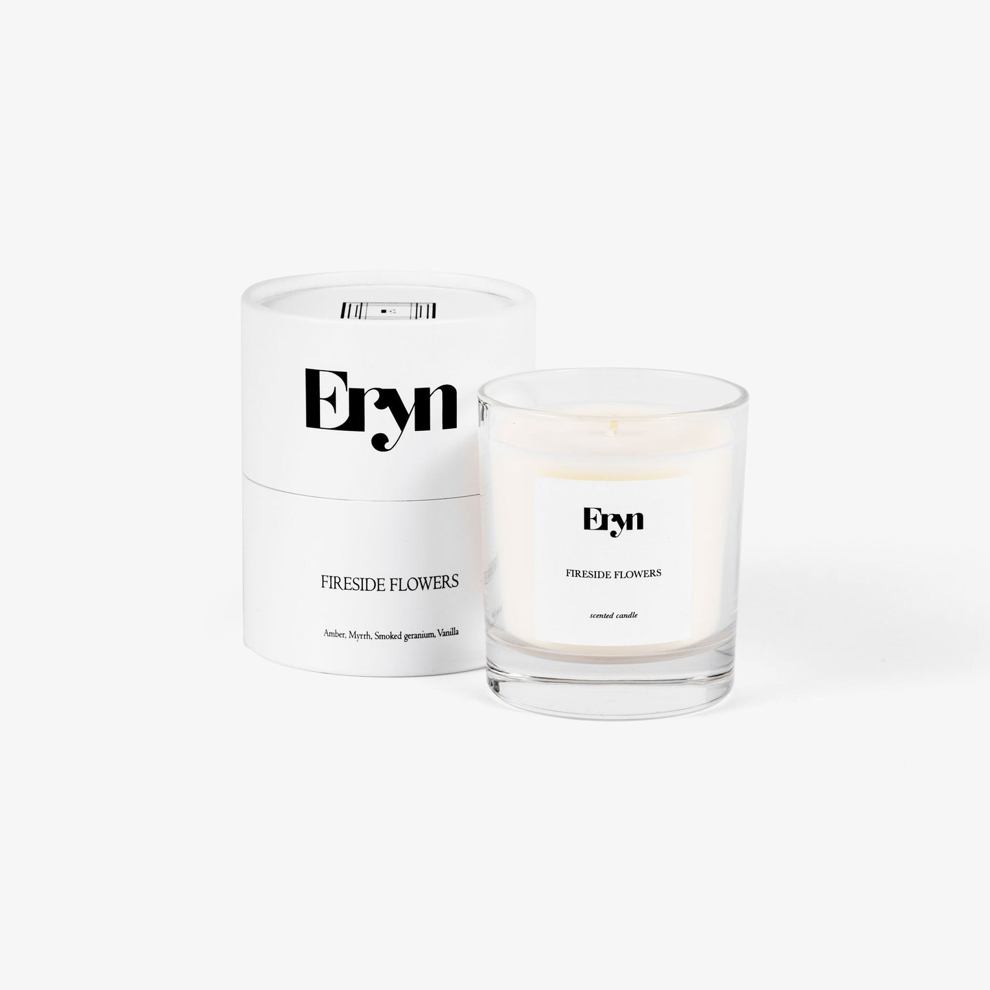 Image of an Eryn scented candle in the scent FIRESIDE FLOWERS alongside its 100% recyclable packaging