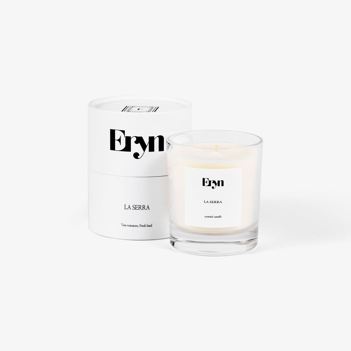 Image of an Eryn candle in the scent LA SERRA alongside its 100% recyclable packaging