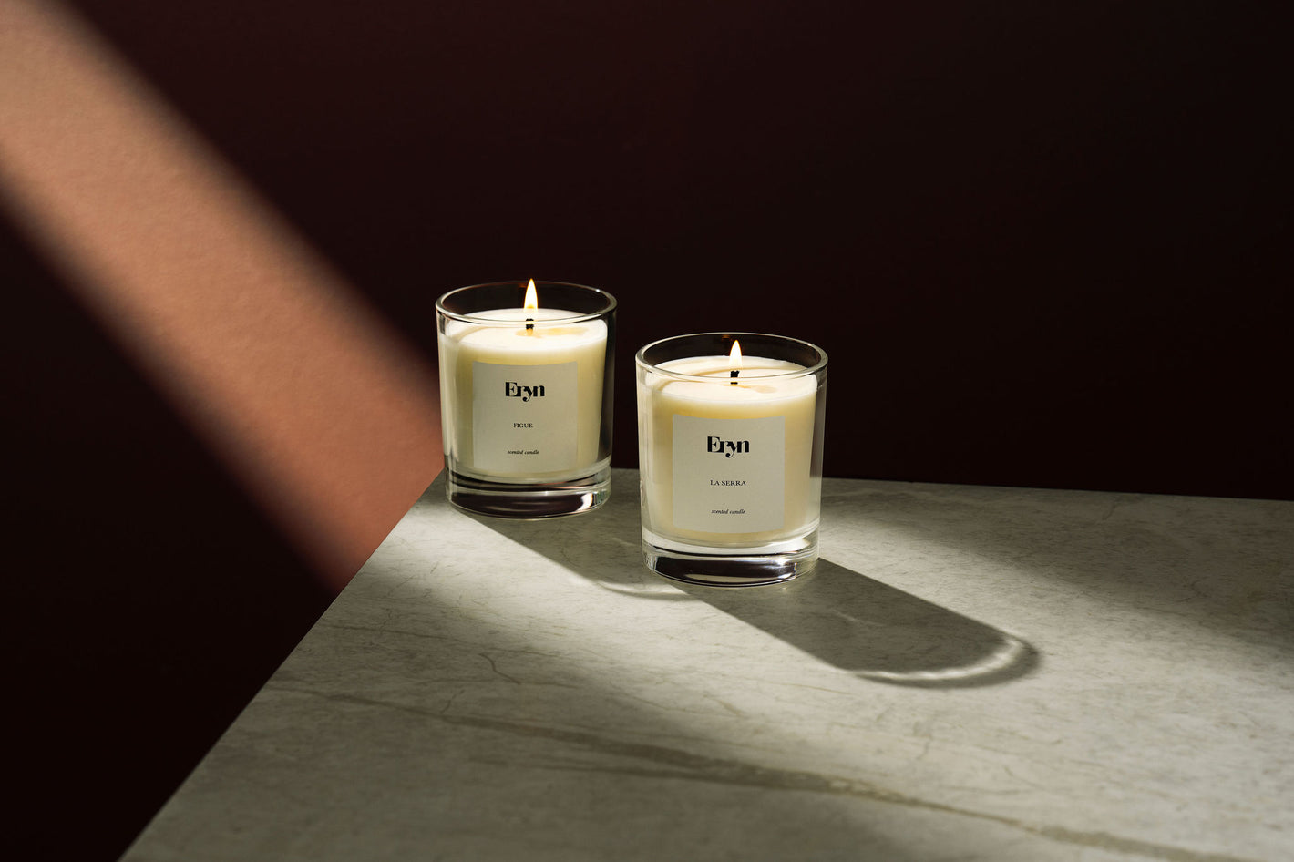 Creative image of two candles from Eryn including La Serra and Figue