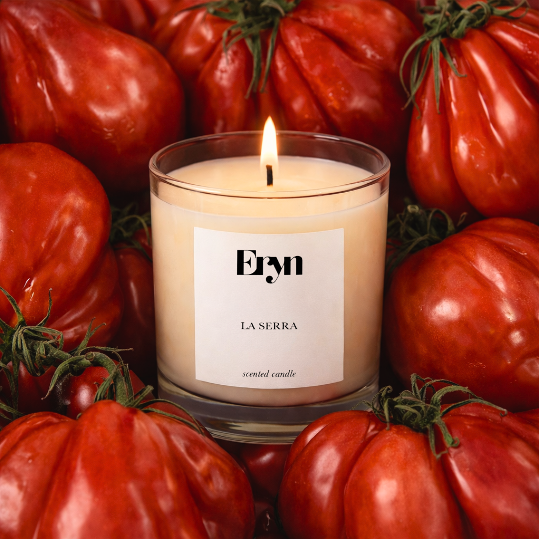 Eryn La Serra clean-burning candle in glass vessel surrounded by vine tomatoes